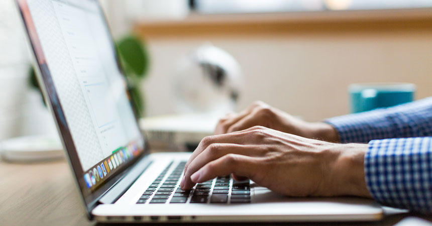 A student typing on a computer