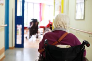 Lone woman in wheelchair seen from the back