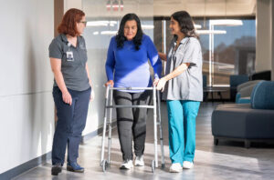 Nurses And Patient With Walker