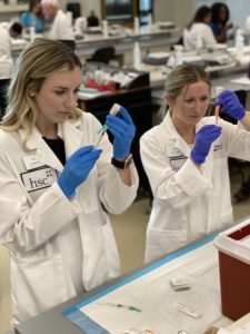 Two students preparing immunizations