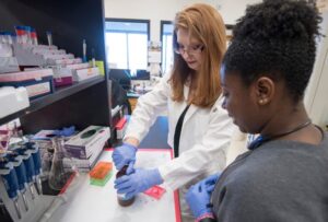 two students working in a pharmacy lab space