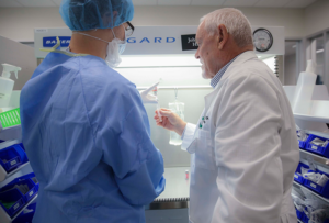 a pharmacy student and instructor at a lab station