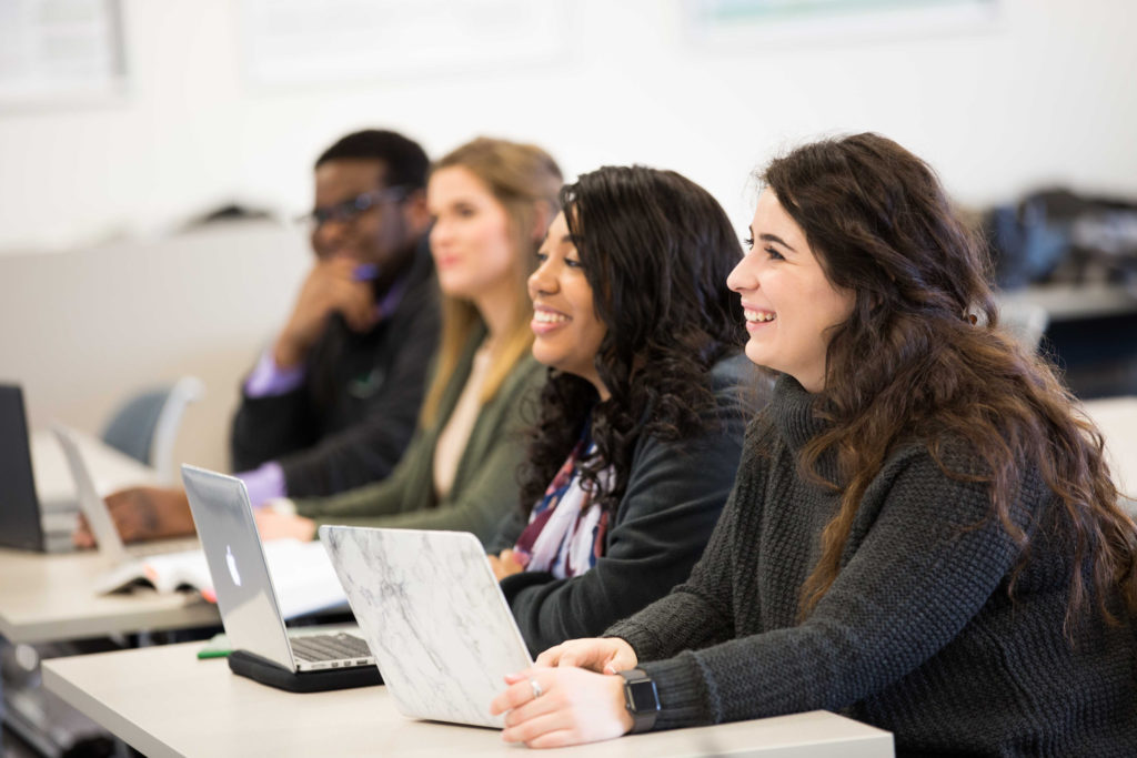 students collaborating at a desk