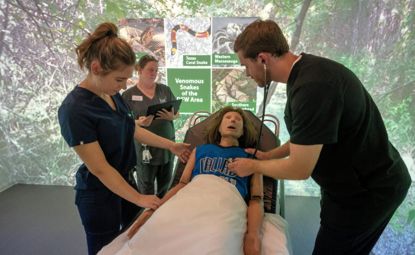 College of Health Professions students working on a dummy in the sim center