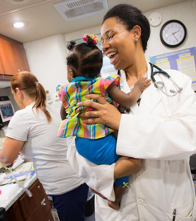 Pediatric Mobile Clinic staff with patient