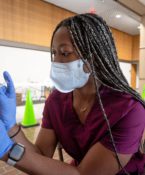 Tcom Student Giving A Flu Shot