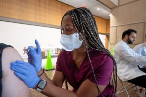 Tcom Student Giving A Flu Shot