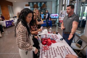 Physical therapy career fair attendee speaking to vendors