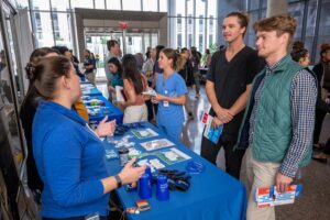 Physical therapy career fair attendee speaking to vendors