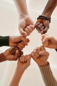 multiple hands doing a group fist bump